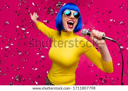 Closeup photo of funny nice lady singer party night club microphone karaoke confetti falling wear specs yellow turtleneck blue wig isolated bright pink color background Royalty-Free Stock Photo #1711807798