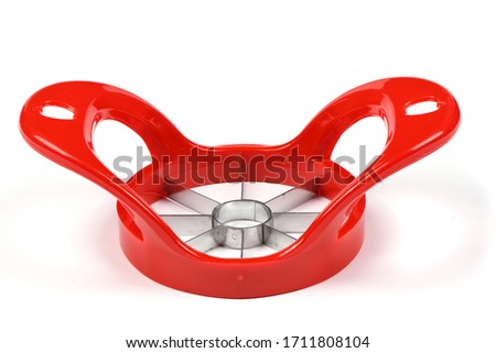 Red device for slicing apples isolated on white background. High resolution photo. Full depth of field.