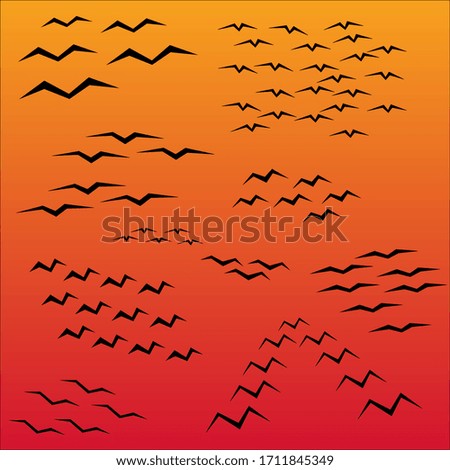 Black geometric birds silhouette in the sky. Isolated minimalistic figures on gradient background, can be used for posters or postcards decoration.