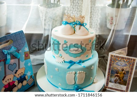 Cake and tasty sweets on table prepared for party.
Beautiful cake with cakes in honor of the birth of a son.