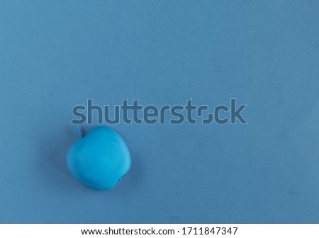 blue apple on a blue background
