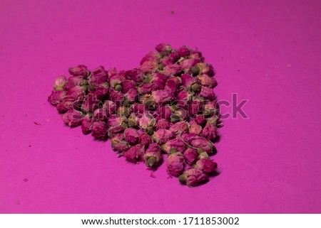 A lot of little pink roses on a pink background - heart-shaped - horizontal photo