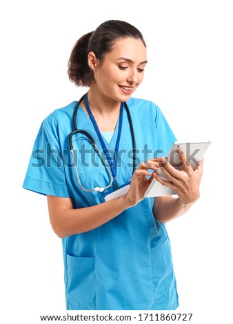 Young female doctor with tablet computer on white background