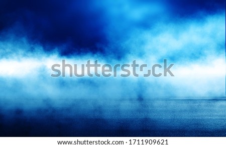 Blue blurred background of the night sky, reflection of the lights of the night city on the pavement. Smoke, fog, smog.