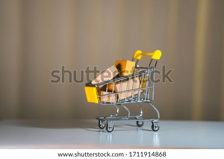 Mini shopping cart contain paper box using as e-commerce, online shopping and business marketing concept
