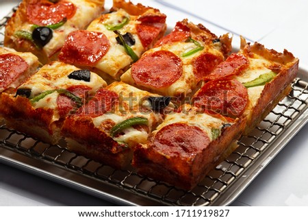 sliced detroit pizza on an iron tray. selective focus Royalty-Free Stock Photo #1711919827
