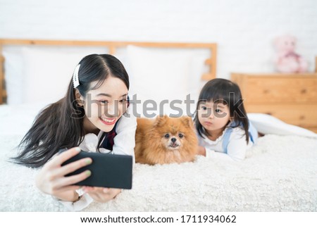 Old sister and sister woman selfie Pomeranian Spitz dogs with mobile phone. Pet Lover Concept.