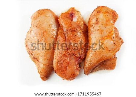 Raw chicken marinated fillet isolated on a white background. Raw chicken breast fillets. top view with copy space. Flat lay composition with raw chicken breasts. Space for text. Meat shop. Royalty-Free Stock Photo #1711955467
