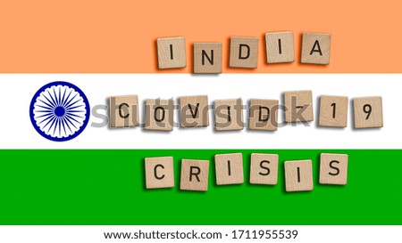 India Covid 19 crisis written with wooden tiles over Indian flag background. Respiratory syndrome coronavirus and Novel coronavirus 2019-nCoV. Virus Pandemic Indian Concept