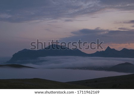 Gloomy mountain landscape with fog