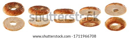 Set of halved bagels with seeds levitating in different positions isolated on white background Royalty-Free Stock Photo #1711966708