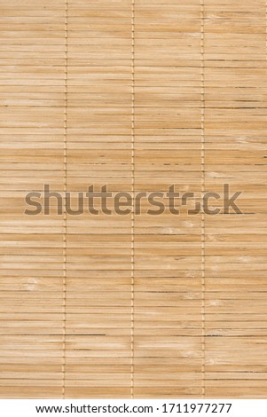 Full frame background of natural unpainted bamboo wood board, natural wood, Texture of wooden slats. Many beige planks on the photo. vertical
