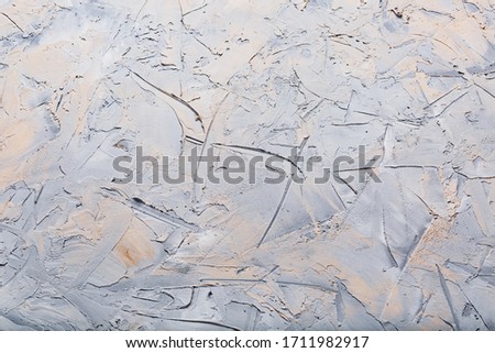 The stone texture background of the wall is gray with flecks.
