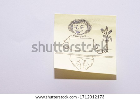 Drawing with marker on sticker. Girl with curly hair works at home at the computer. Freelance work