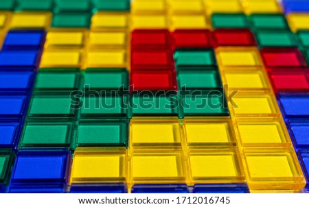 Colorful matching blocks on white background, high contrast colours, red blue yellow and green transparent tiles matched to create a mosaic pattern filling the whole picture