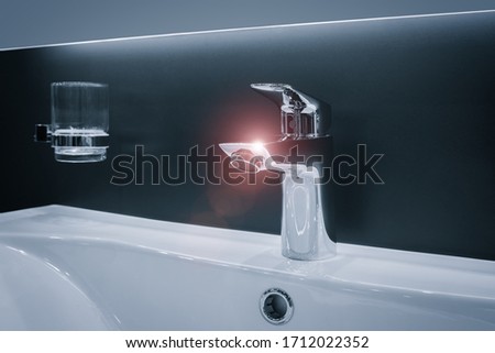 Hygiene concept. Luxury modern style faucet on a white sink in a beautiful bathroom