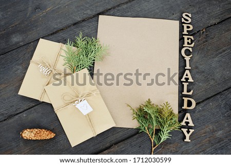 Three craft envelopes and a piece of craft paper. Place for your text and message. Handmade gift wrap. The lettering is the inscription "special day".