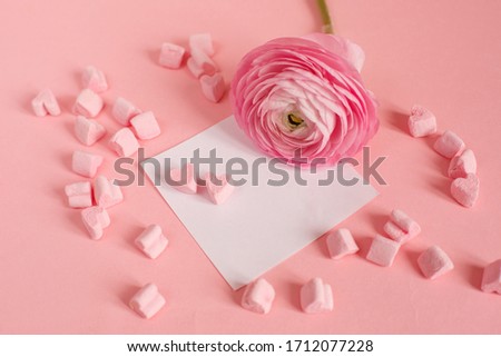 good morning card in pink. a marshmallow and a pink flower , an empty piece of paper, a note, space for text on a pink background.