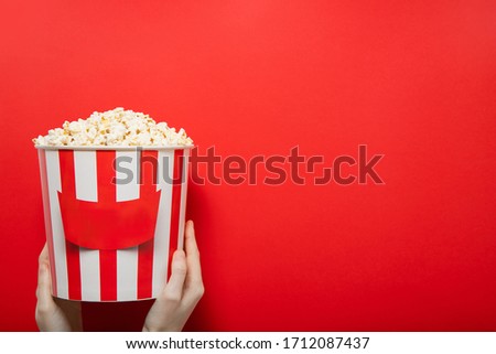 Popcorn on a red background. Place for text