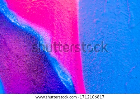 Beautiful bright colorful street art graffiti background. Abstract creative spray drawing fashion colors on the walls of the city. Urban Culture, crimson ,blue, purple , violet , neon texture