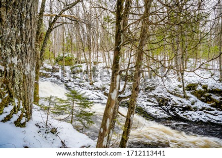 A small waterfall with snow.