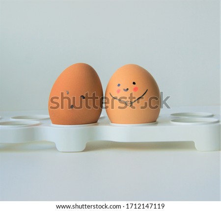 Two boiled faced eggs in relationship 