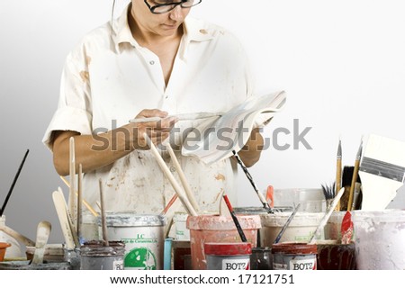 Picture of a potter painting a clay piece
