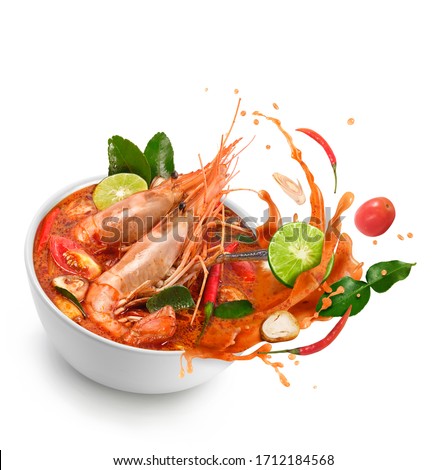 Thai food Tom Yum Kung.Thai hot and spicy soup shrimp in bowl.with Straw Mushroom,lime,Kaffir lime leaves,tomato and chilli. Splash on the air. isolated on white background. Royalty-Free Stock Photo #1712184568
