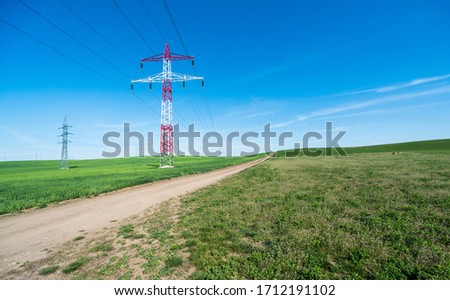 Electric pole in the center of the beautiful green fields, electric pylon, tower