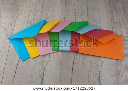 colorful envelopes lying on old wooden table with copy space  