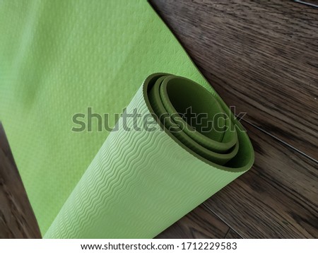 Yoga mat in green. Equipment for yoga. Healthy lifestyle concept