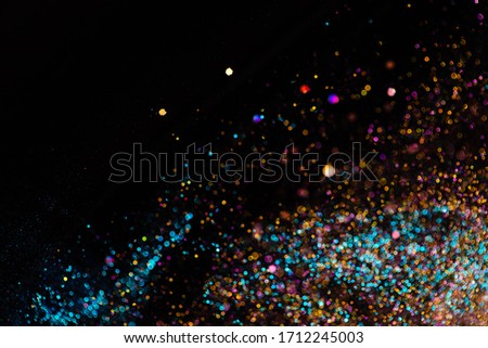 Festive bokeh lights background, abstract sparkle backdrop with circles,modern design wallpaper with sparkling glimmers. Surface with Vivid colors, glittering sparkle and glow effect. Royalty-Free Stock Photo #1712245003