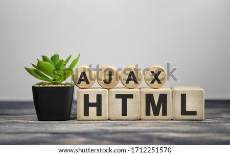 AJAX HTML - text on wooden cubes, green plant in black pot on a wooden background