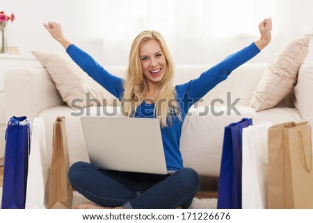 Excited young woman with online shopping 