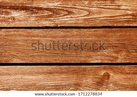 Old grungy wooden planks background in orange tone. Abstract background and texture for design.
