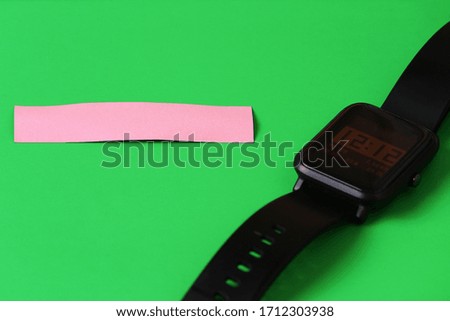 Clean sticker, space for text or inscription, on green background with smart watch.