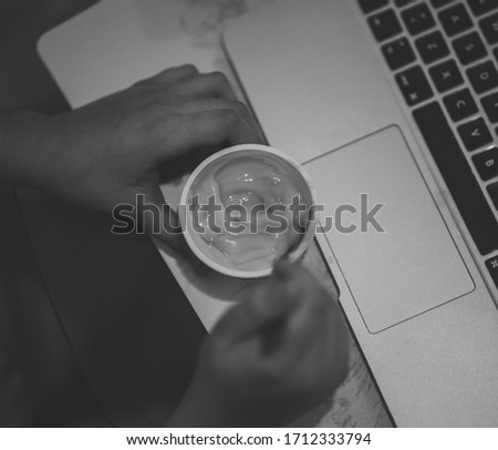 hand laptop computing yogurt snack white black isolated technology study human people office keyboard work