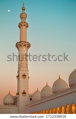 Beautiful colorful sunset with mosque domes and moon, Ramadan fasten vibes at Abu Dhabi Royalty-Free Stock Photo #1712338018