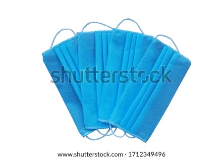 Disposable blue masks isolated on a white background. Medical procedure mask. Medical surgical mask. Wearing mask in public. Coronavirus pandemic concept.