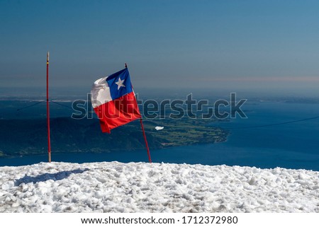 Chile flag on the Osorno volcano, Puerto Varas, Llanquihue province, Los Lagos, Chile on November 6, 2015. Andes and Chilean Patagonia.