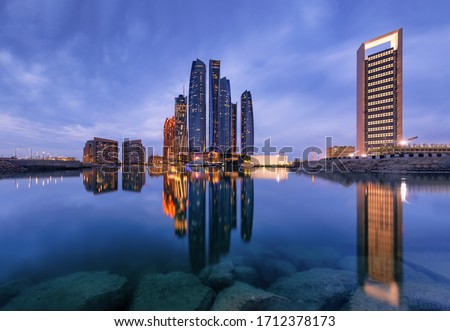 Abu Dhabi Skyline and Etihad Towers in Sunset time with Reflection United Arab Emirates, 