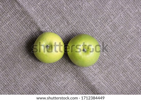 Green apples on burlap background. Copy space.