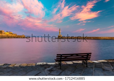 Panorama of venetian harbour waterfront and lighthouse in old harbour of Chania, Crete, Greece. Old venetian lighthouse in Chania, Greece. Lighthouse of the old Venetian port in Chania, Greece. Royalty-Free Stock Photo #1712416885