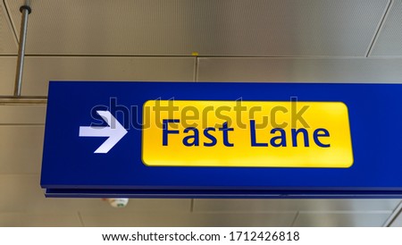 Fast Lane sign in blue and yellow at the airport close up. Fast Lane sign airport first class luxury notification.