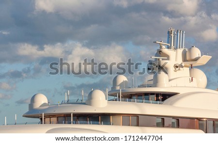 Cabin of a cruise yacht on the background of sunset clouds