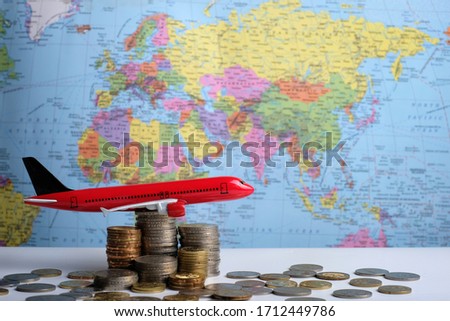 Grown up coins and aeroplane on world map background,world business concept