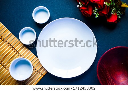 
Gastronomic background with free space for text. utensils, dish towel, blue metal surface, wooden bowl, Top view.