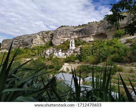 A beautiful summer landscape with a view of the Church of the Assumption Monastery near the town of Bakhchisarai in the Crimea is located in a mountain valley near the ancient cave city of Chufut-Kale