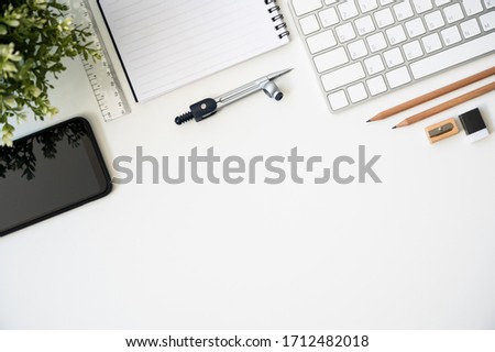 Top view table desk of office architect pencil, compasses tool, ruler, rubber, protractor grid, sharpener, glasses, smartphone, keyboard with copy space background.