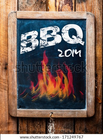 Rustic advertisement for a BBQ on a vintage kids school slate with a picture of red hot flames and an annotation at the bottom saying - Mans stuff